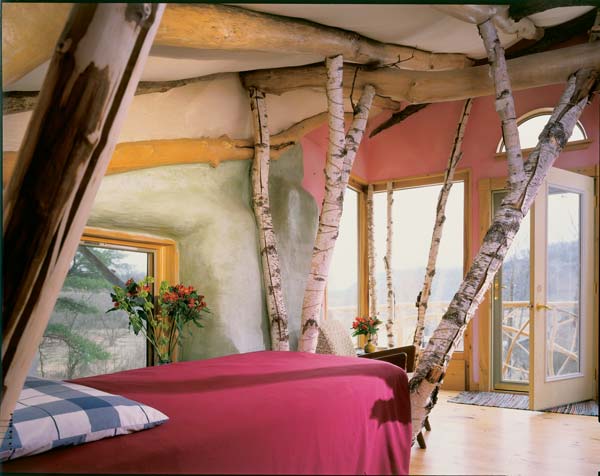 Marcia's bed is framed with birch trees, which recall fond memories of her youth. A cedar drawer beneath provides the foundation for the mattress. She can see the river from her balcony.